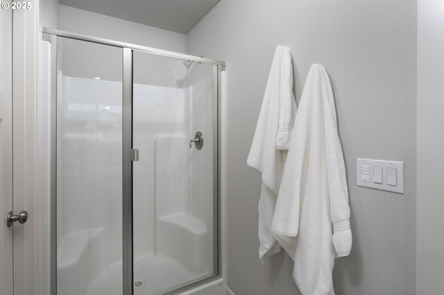 31380 NW Turel Dr, North Plains, OR 97133 - bathroom featuring a stall shower and a textured ceiling