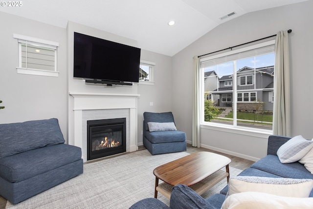 31380 NW Turel Dr, North Plains, OR 97133 - living area featuring lofted ceiling, healthy amount of natural light, a glass covered fireplace, recessed lighting, and baseboards