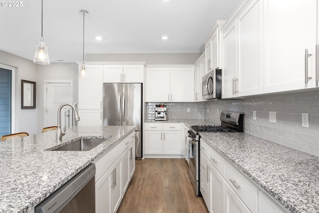 31380 NW Turel Dr, North Plains, OR 97133 - kitchen with stainless steel appliances, a sink, white cabinetry, and recessed lighting