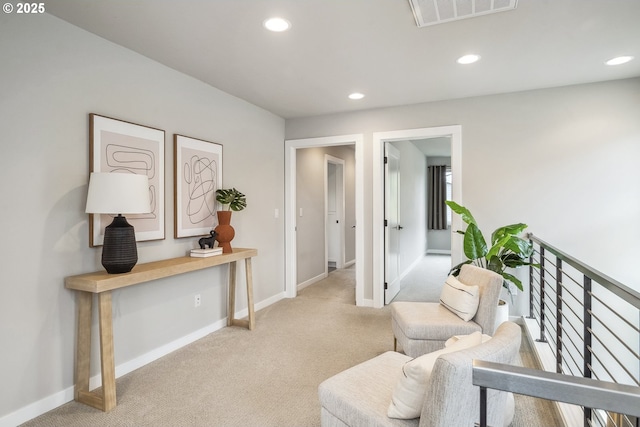 living area featuring light carpet