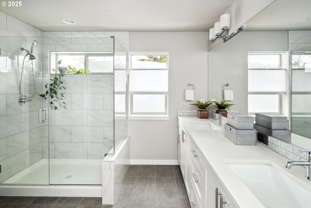 bathroom featuring a shower with door, vanity, and tile patterned floors