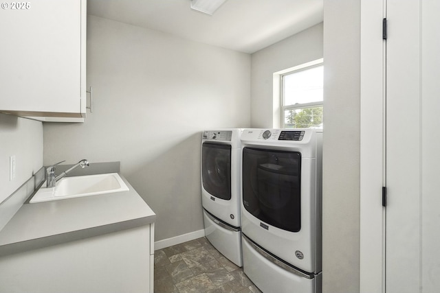 laundry area with sink, cabinets, and washer and dryer