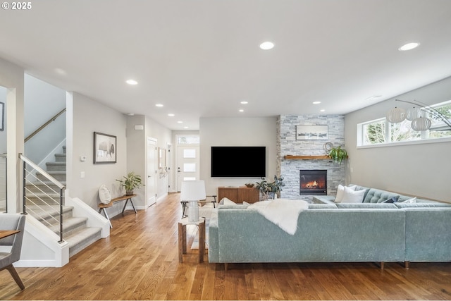 living room with a fireplace and wood-type flooring