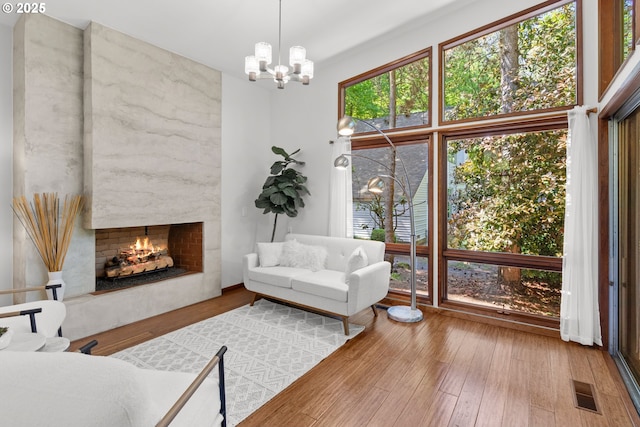 3115 NW Cornell Rd, Portland, OR 97210 - living area with a chandelier, wood finished floors, and a high end fireplace