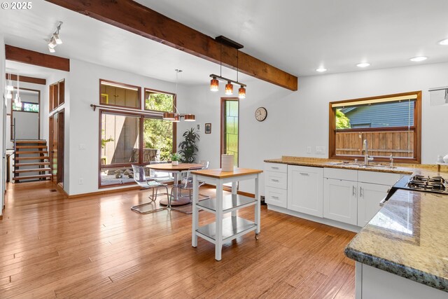 3115 NW Cornell Rd, Portland, OR 97210 - kitchen with a sink, beam ceiling, recessed lighting, white cabinets, and light wood finished floors