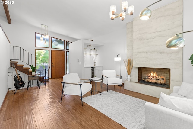 3115 NW Cornell Rd, Portland, OR 97210 - living area featuring a chandelier, wine cooler, a premium fireplace, stairs, and wood finished floors