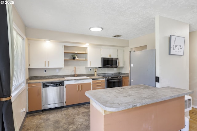 11547 NE San Rafael St, Portland, OR 97220 - kitchen with stainless steel appliances, a sink, plenty of natural light, open shelves, and a textured ceiling