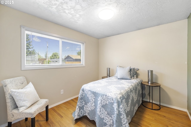 11547 NE San Rafael St, Portland, OR 97220 - bedroom featuring wood finished floors, baseboards, and a textured ceiling