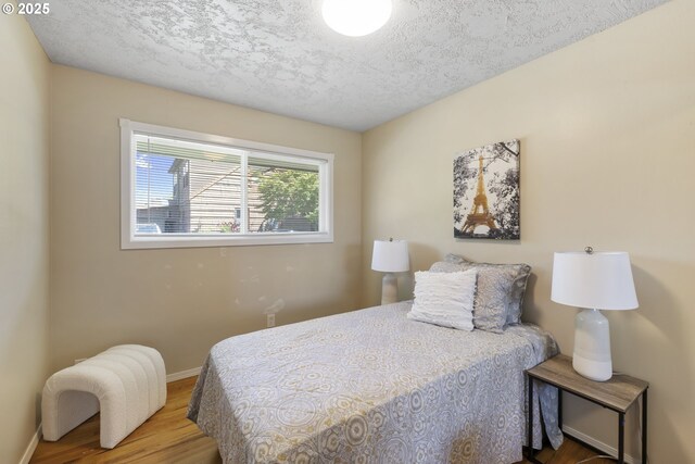 11547 NE San Rafael St, Portland, OR 97220 - bedroom featuring wood finished floors, baseboards, and a textured ceiling