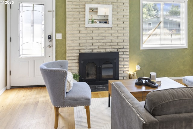11547 NE San Rafael St, Portland, OR 97220 - living area with a fireplace, light wood finished floors, and baseboards