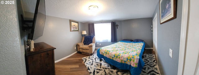 2453 Stephanie Ln, North Bend, OR 97459 - bedroom featuring wood finished floors, baseboards, and a textured ceiling
