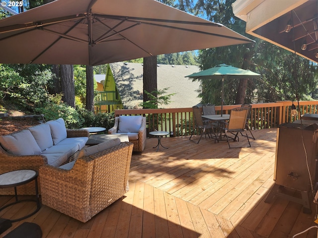 deck with outdoor dining space and an outdoor living space