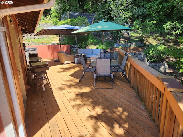 wooden deck featuring outdoor dining area and an outdoor hangout area