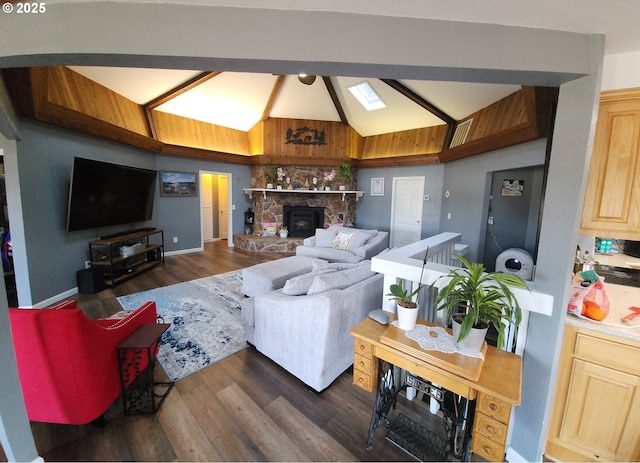 living room featuring baseboards, vaulted ceiling, and dark wood finished floors