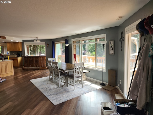dining room featuring baseboards, dark wood-style floors, and visible vents