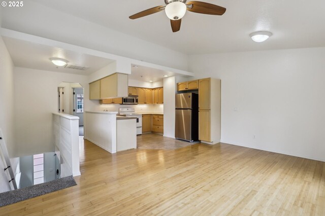 433 Harris Ln, Oregon City, OR 97045 - kitchen with appliances with stainless steel finishes, light wood-style flooring, a peninsula, a ceiling fan, and light countertops