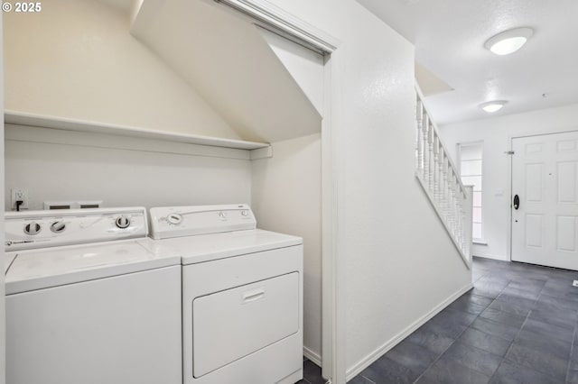 laundry area with washer and clothes dryer and baseboards
