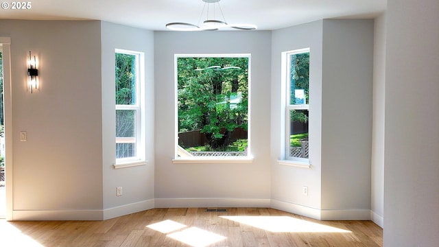 13511 SE Barbara Jean Ct, Clackamas, OR 97015 - spare room featuring light wood-type flooring, healthy amount of natural light, baseboards, and a chandelier
