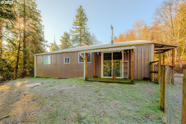 rear view of house featuring a yard