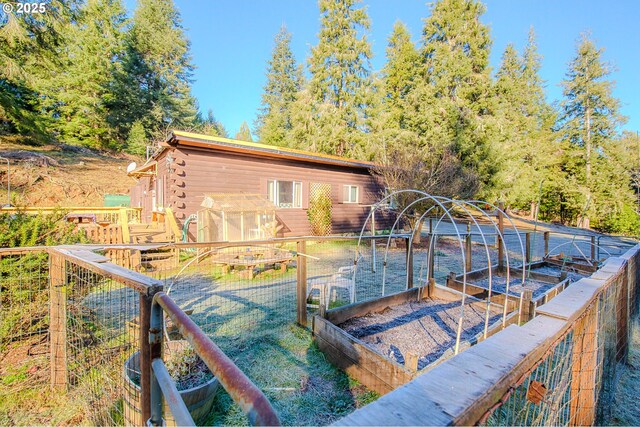 rear view of house featuring a wooden deck