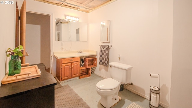 bathroom featuring vanity, concrete floors, and toilet