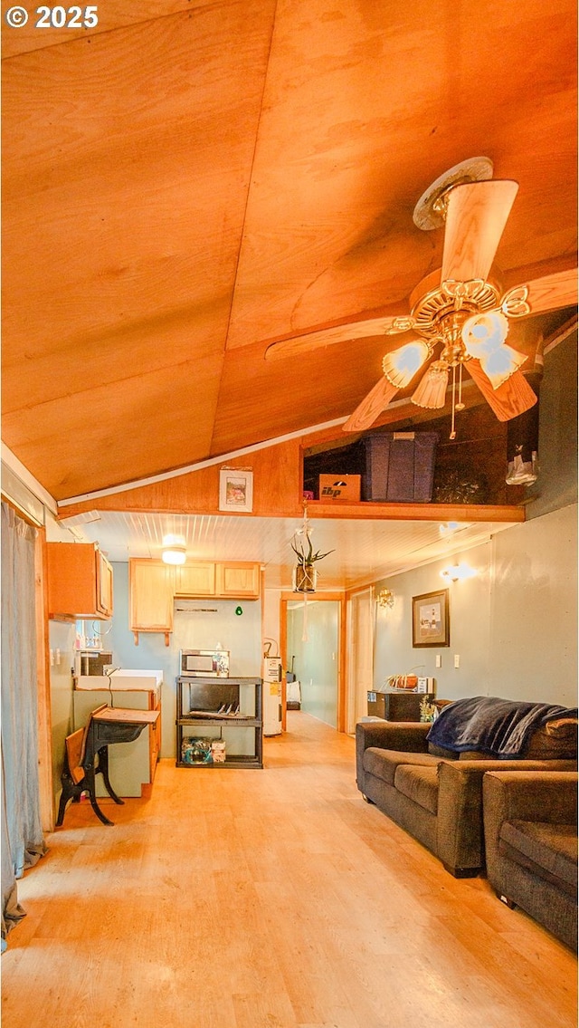 living room featuring lofted ceiling, hardwood / wood-style flooring, and ceiling fan