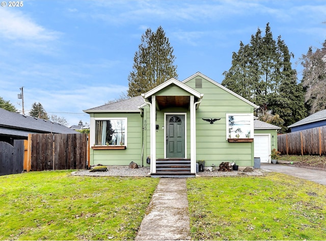 bungalow-style house featuring a front yard and a garage