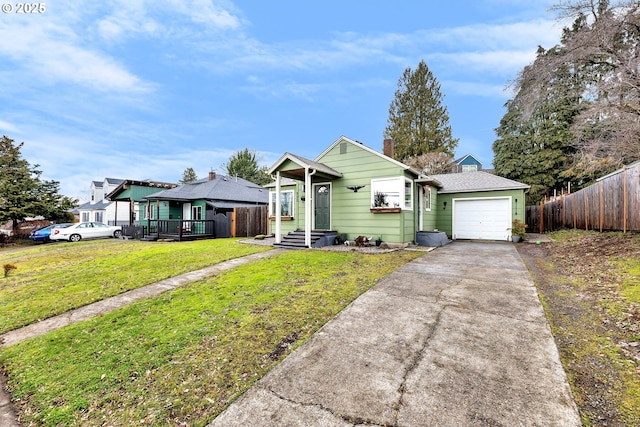 bungalow-style house featuring a garage and a front lawn