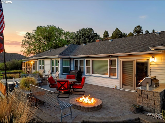 40290 Beaver Creek Loop, Baker City, OR 97814 - patio terrace at dusk featuring a fire pit, a patio area, and a grill