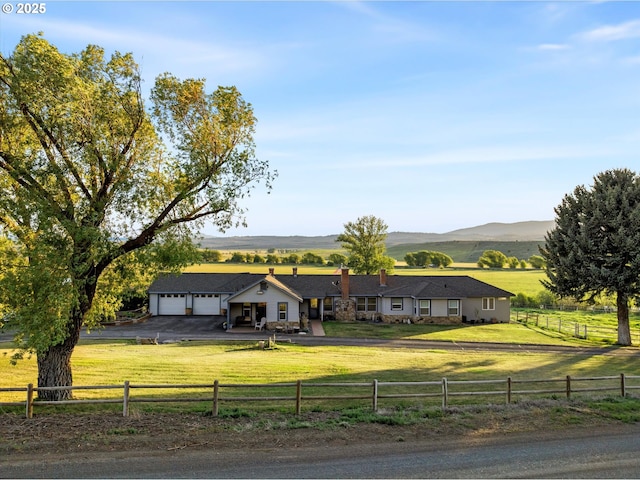 40290 Beaver Creek Loop, Baker City, OR 97814 - ranch-style home featuring a rural view, asphalt driveway, an attached garage, and a mountain view