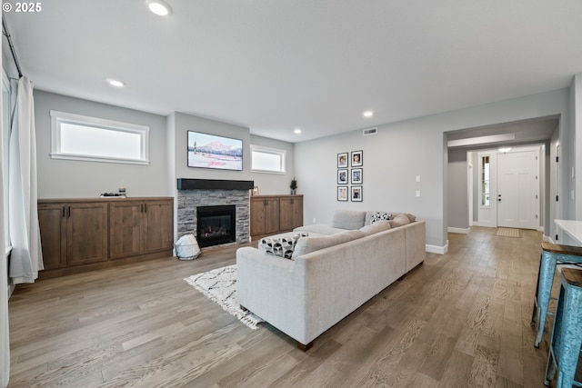 4342 S 16th Way, Ridgefield, WA 98642 - living room with light wood finished floors, a stone fireplace, recessed lighting, and baseboards
