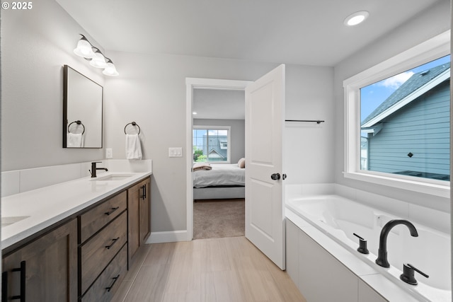 4342 S 16th Way, Ridgefield, WA 98642 - ensuite bathroom with double vanity, a bath, baseboards, and recessed lighting