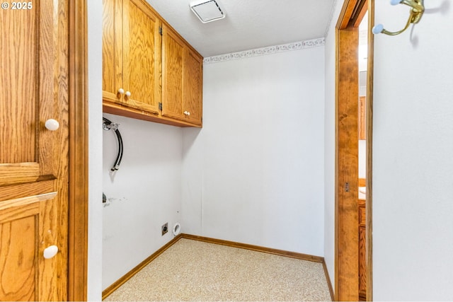 laundry area with cabinet space, baseboards, and light carpet
