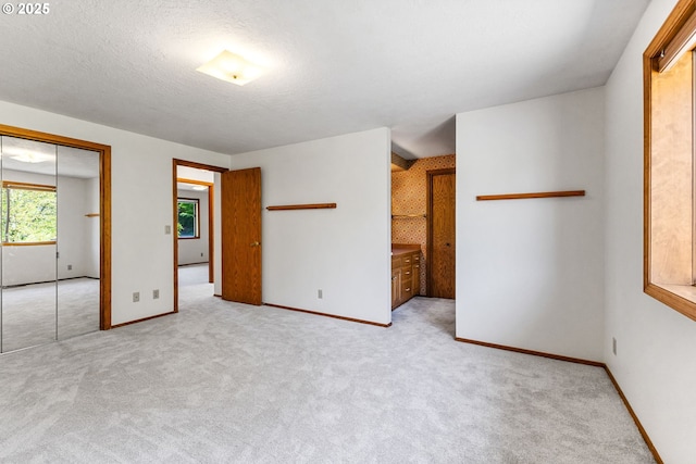 carpeted empty room featuring baseboards