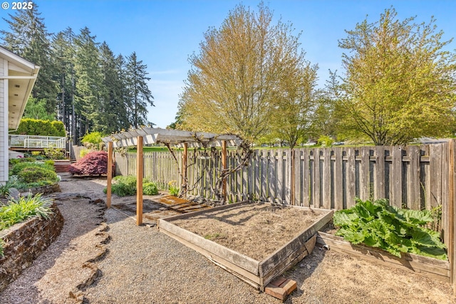 view of yard with a garden, fence, and a pergola