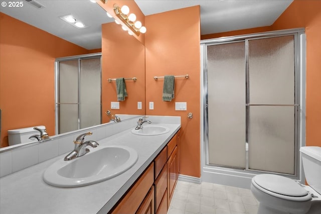 14255 SW Parmele Rd, Gaston, OR 97119 - full bathroom featuring toilet, an enclosed shower, double vanity, and baseboards
