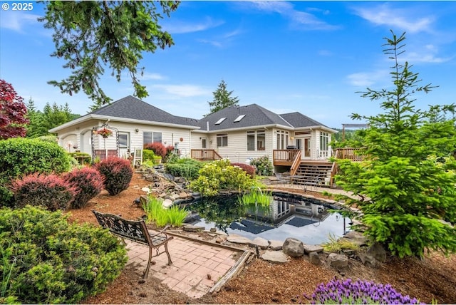 14255 SW Parmele Rd, Gaston, OR 97119 - rear view of property featuring a wooden deck, a patio, and a garden pond