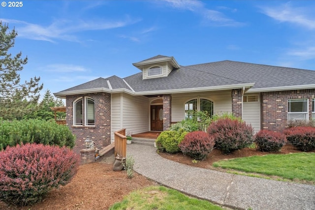 14255 SW Parmele Rd, Gaston, OR 97119 - view of front facade with brick siding, a porch, and roof with shingles