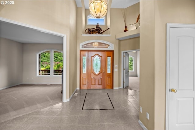 14255 SW Parmele Rd, Gaston, OR 97119 - foyer featuring baseboards, a high ceiling, tile patterned flooring, carpet floors, and a chandelier