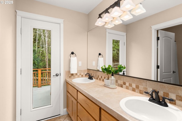 bathroom featuring a sink, decorative backsplash, and double vanity