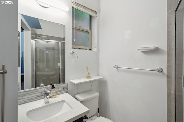full bathroom with a stall shower, toilet, and vanity