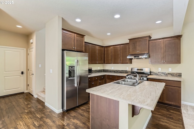 7156 NW Abigail Ter, Portland, OR 97229 - kitchen with under cabinet range hood, appliances with stainless steel finishes, a sink, and dark wood-type flooring