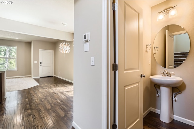 7156 NW Abigail Ter, Portland, OR 97229 - bathroom featuring a sink, baseboards, wood finished floors, and a chandelier