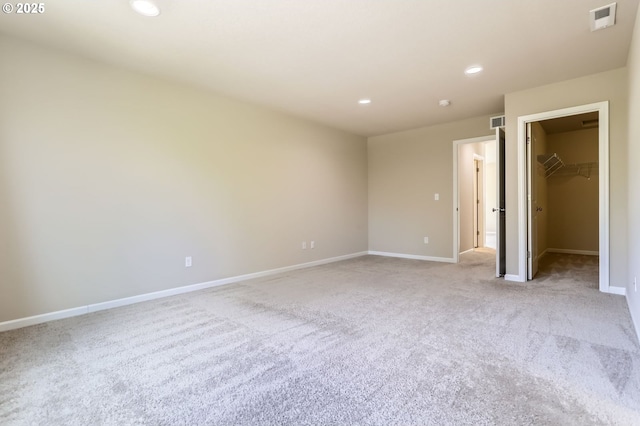 7156 NW Abigail Ter, Portland, OR 97229 - unfurnished bedroom with carpet floors, visible vents, baseboards, a walk in closet, and recessed lighting
