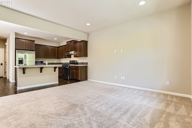 7156 NW Abigail Ter, Portland, OR 97229 - kitchen with a kitchen breakfast bar, baseboards, appliances with stainless steel finishes, and dark brown cabinets