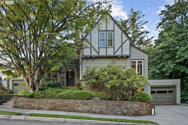 3505 SW Beaverton Ave, Portland, OR 97239 - tudor-style house with concrete driveway and a garage