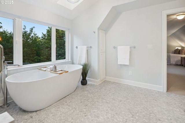 3505 SW Beaverton Ave, Portland, OR 97239 - full bath featuring a freestanding bath, connected bathroom, a skylight, and lofted ceiling