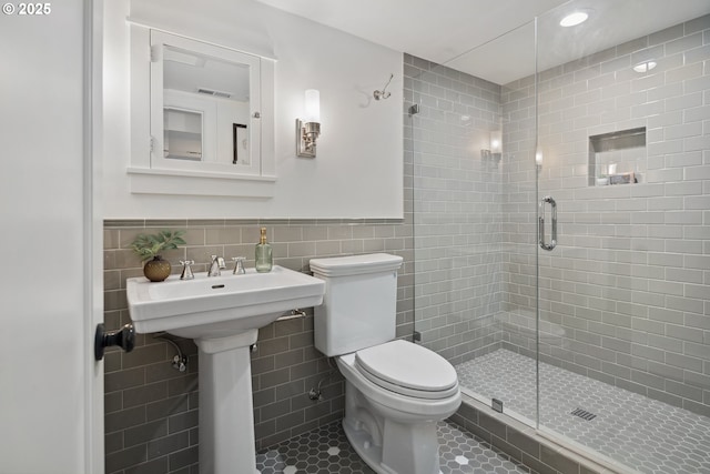 3505 SW Beaverton Ave, Portland, OR 97239 - full bathroom featuring tile walls, a stall shower, tile patterned floors, and wainscoting