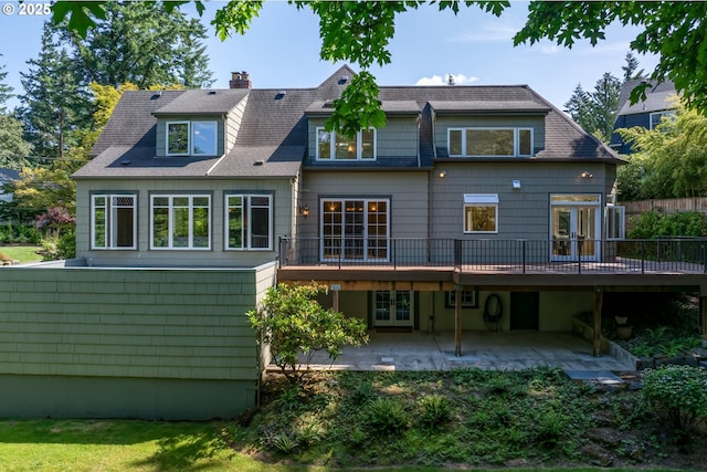 3505 SW Beaverton Ave, Portland, OR 97239 - rear view of house featuring french doors, a patio, a deck, and a chimney