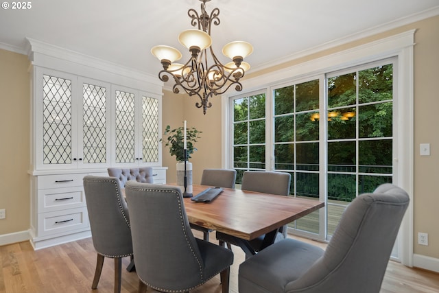 3505 SW Beaverton Ave, Portland, OR 97239 - dining room with a chandelier, ornamental molding, plenty of natural light, and light wood-style flooring